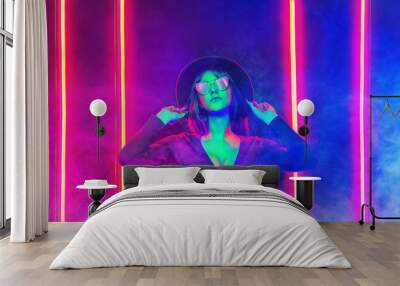 Neon close up portrait of young woman in red sunglasses. 80`s disco style. Wall mural